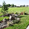 Residence off of McKay Rd. Prineville, Or.  with dry stream bed turf , shrubs and automatic irrigation system.