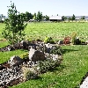 Residence off of McKay Rd. Prineville, Or.  with dry stream bed turf , shrubs and automatic irrigation system.